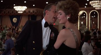 Movie still from “No Way Out” (1987), directed by Roger Donaldson – A man and a woman in formal wear at a formal event; Medium shot, Low angle