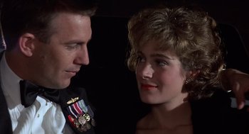 Movie still from “No Way Out” (1987), directed by Roger Donaldson – A man and a woman looking at one another; Close Up shot, Low angle