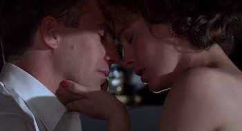 Movie still from “No Way Out” (1987), directed by Roger Donaldson – A man and a woman touching each other's lips; Extreme Close Up shot, Low angle