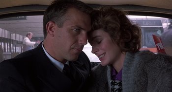 Movie still from “No Way Out” (1987), directed by Roger Donaldson – A man and a woman sitting in a car together; Close Up shot, Low angle