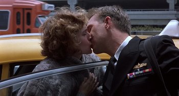 Movie still from “No Way Out” (1987), directed by Roger Donaldson – A man and a woman kissing in a car; Close Up shot, Low angle