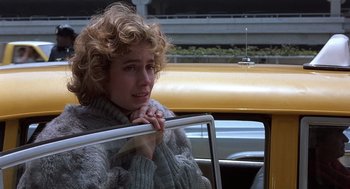 Movie still from “No Way Out” (1987), directed by Roger Donaldson – A woman sitting in the passenger seat of a car; Close Up shot, Over the shoulder angle
