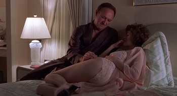 Movie still from “No Way Out” (1987), directed by Roger Donaldson – A man and a woman in lingerie on a bed; Medium shot, Low angle