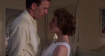 Movie still from “No Way Out” (1987), directed by Roger Donaldson – A man and a woman standing next to each other; Close Up shot, Low angle