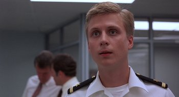 Movie still from “No Way Out” (1987), directed by Roger Donaldson – A man in a uniform looking up at the sky; Close Up shot, Low angle