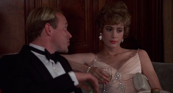 Movie still from “No Way Out” (1987), directed by Roger Donaldson – A man and a woman in formal wear drinking wine; Close Up shot, Over the shoulder angle