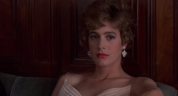 Movie still from “No Way Out” (1987), directed by Roger Donaldson – A woman in a white dress with red lipstick; Close Up shot, Low angle