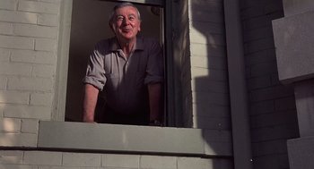 Movie still from “No Way Out” (1987), directed by Roger Donaldson – An older man standing in a window sill; Medium shot, Low angle