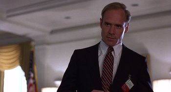 Movie still from “No Way Out” (1987), directed by Roger Donaldson – A man in a suit and a tie; Close Up shot, Low angle