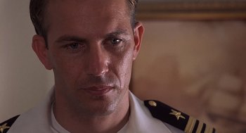 Movie still from “No Way Out” (1987), directed by Roger Donaldson – A person wearing a military uniform; Close Up shot, Low angle
