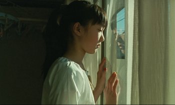 Movie still from “Nobody Knows” (2004), directed by Kore-eda Hirokazu – A young girl looking out of a window; Close Up shot, Over the shoulder angle