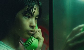Movie still from “Nobody Knows” (2004), directed by Kore-eda Hirokazu – A person with a green phone in a room; Close Up shot, Low angle