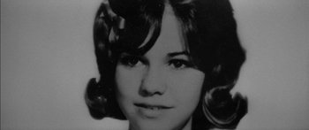 Movie still from “Norma Rae” (1979), directed by Martin Ritt – An old black and white photo of a young woman; Close Up shot, High angle