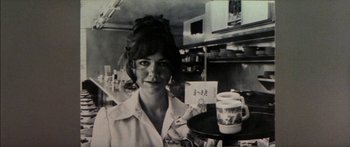 Movie still from “Norma Rae” (1979), directed by Martin Ritt – A black and white photo of a woman holding a tray of food; Close Up shot, Low angle