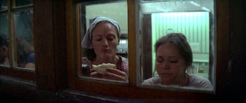 Movie still from “Norma Rae” (1979), directed by Martin Ritt – Two women sitting in front of a window eating a sandwich; Close Up shot, Over the shoulder angle