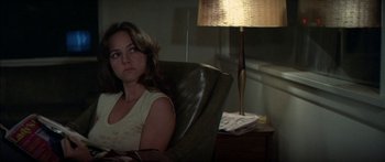 Movie still from “Norma Rae” (1979), directed by Martin Ritt – A woman sitting in a chair in front of a lamp; Close Up shot, Over the shoulder angle