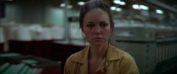 Movie still from “Norma Rae” (1979), directed by Martin Ritt – A woman in a yellow shirt is looking at the camera; Close Up shot, Low angle