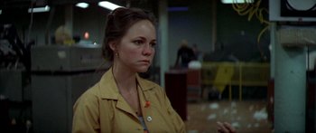 Movie still from “Norma Rae” (1979), directed by Martin Ritt – A woman in a yellow shirt is looking at the camera; Close Up shot, Low angle