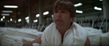 Movie still from “Norma Rae” (1979), directed by Martin Ritt – A man wearing a white blanket and a white scarf; Close Up shot, Low angle