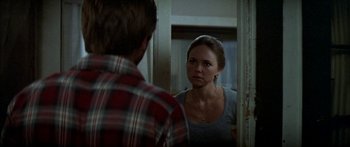 Movie still from “Norma Rae” (1979), directed by Martin Ritt – A man and a woman looking at each other in a mirror; Close Up shot, Over the shoulder angle