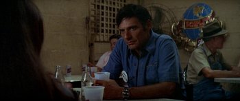 Movie still from “Norma Rae” (1979), directed by Martin Ritt – A man sitting at a table in front of drinks; Close Up shot, Over the shoulder angle