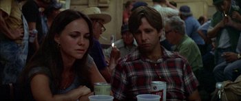 Movie still from “Norma Rae” (1979), directed by Martin Ritt – A man and a woman sitting at a table with drinks; Close Up shot, Over the shoulder angle