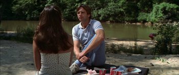 Movie still from “Norma Rae” (1979), directed by Martin Ritt – A man sitting on the ground next to a woman; Medium shot, Over the shoulder angle