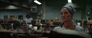 Movie still from “Norma Rae” (1979), directed by Martin Ritt – A woman with a headset in a room with other people; Close Up shot, Low angle