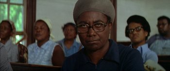 Movie still from “Norma Rae” (1979), directed by Martin Ritt – An older man wearing glasses and a hat; Close Up shot, Over the shoulder angle