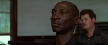 Movie still from “Norma Rae” (1979), directed by Martin Ritt – An older black man looking up into the sky; Close Up shot, Low angle