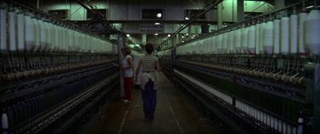 Movie still from “Norma Rae” (1979), directed by Martin Ritt – Two women are walking down a path in a factory; Wide shot, High angle