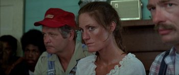 Movie still from “Norma Rae” (1979), directed by Martin Ritt – A person wearing a red hat; Close Up shot, Over the shoulder angle