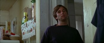 Movie still from “Norma Rae” (1979), directed by Martin Ritt – A man standing in front of a door looking to his left; Close Up shot, Low angle