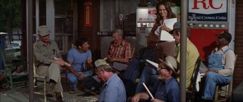 Movie still from “Norma Rae” (1979), directed by Martin Ritt – A group of men and women sitting on the ground; Wide shot, High angle