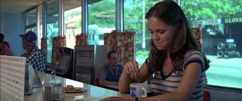 Movie still from “Norma Rae” (1979), directed by Martin Ritt – A woman sitting at a table with a cup of coffee in front of a man; Medium shot, Over the shoulder angle