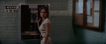 Movie still from “Norma Rae” (1979), directed by Martin Ritt – A woman standing in front of a phone booth; Medium shot, Low angle