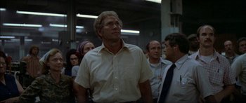 Movie still from “Norma Rae” (1979), directed by Martin Ritt – A group of people standing in a room; Medium shot, Low angle