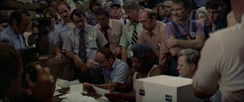 Movie still from “Norma Rae” (1979), directed by Martin Ritt – A group of men sitting around a table; Medium shot, High angle