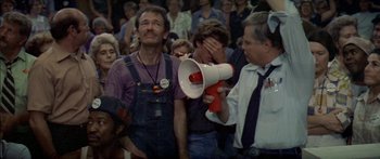 Movie still from “Norma Rae” (1979), directed by Martin Ritt – A group of people that are standing in a room; Medium shot, High angle