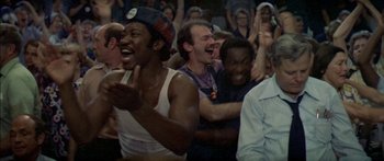 Movie still from “Norma Rae” (1979), directed by Martin Ritt – A group of people that are sitting in a room; Medium shot, Over the shoulder angle