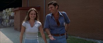 Movie still from “Norma Rae” (1979), directed by Martin Ritt – A man and a woman are walking together outside; Medium shot, Low angle