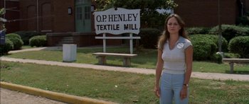 Movie still from “Norma Rae” (1979), directed by Martin Ritt – A woman standing in front of a sign that says " o; Wide shot, Low angle