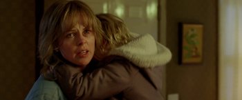 Movie still from “North Country” (2005), directed by Niki Caro – A woman holding a child in her arms; Close Up shot, Over the shoulder angle