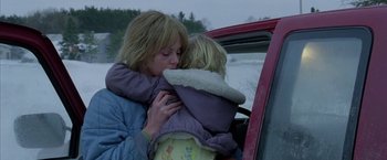 Movie still from “North Country” (2005), directed by Niki Caro – A woman and a child are hugging in a car; Close Up shot, Low angle