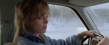 Movie still from “North Country” (2005), directed by Niki Caro – A woman sitting in the passenger seat of a car in the snow; Close Up shot, Over the shoulder angle