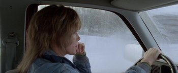 Movie still from “North Country” (2005), directed by Niki Caro – A woman sitting in the passenger seat of a car looking out the window; Close Up shot, Over the shoulder angle