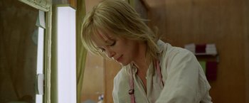 Movie still from “North Country” (2005), directed by Niki Caro – A woman with blonde hair wearing a white shirt; Close Up shot, Low angle