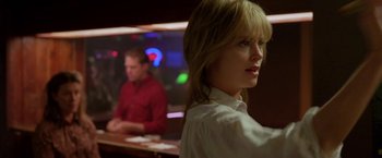 Movie still from “North Country” (2005), directed by Niki Caro – A woman standing in front of a man sitting at a bar; Close Up shot, Over the shoulder angle