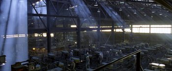 Movie still from “North Country” (2005), directed by Niki Caro – A group of men working inside a factory; Extreme Wide shot, High angle