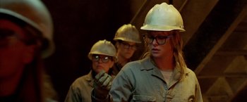 Movie still from “North Country” (2005), directed by Niki Caro – A group of people wearing hard hats and gloves; Medium shot, Low angle